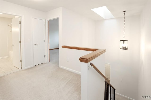 442 Summerhaven Dr N, Manlius, NY 13057 - hall featuring a skylight, an upstairs landing, carpet, and baseboards