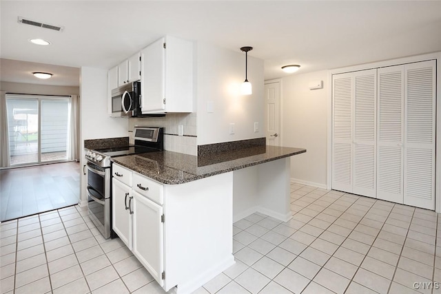 442 Summerhaven Dr N, Manlius, NY 13057 - kitchen with stainless steel appliances, light tile patterned floors, white cabinets, and dark stone countertops
