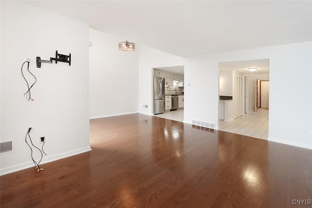 442 Summerhaven Dr N, Manlius, NY 13057 - unfurnished living room featuring light wood-style floors and baseboards