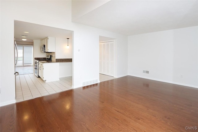 442 Summerhaven Dr N, Manlius, NY 13057 - unfurnished living room featuring baseboards and light wood finished floors