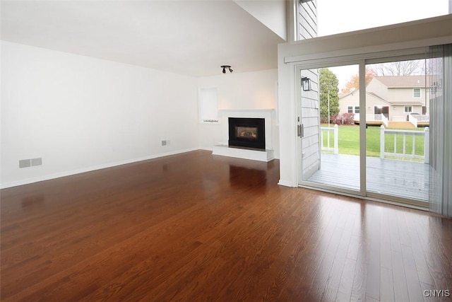442 Summerhaven Dr N, Manlius, NY 13057 - unfurnished living room featuring dark wood-style flooring, a glass covered fireplace, and baseboards