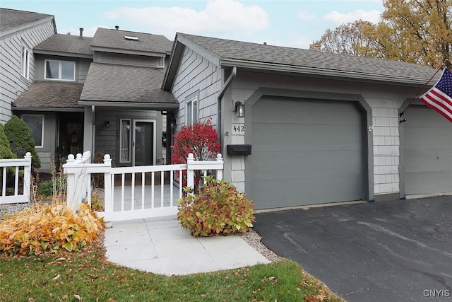 442 Summerhaven Dr N, Manlius, NY 13057 - view of front facade featuring a shingled roof, asphalt driveway, and a garage