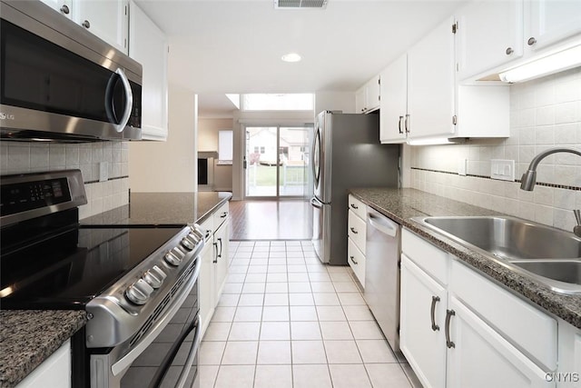 442 Summerhaven Dr N, Manlius, NY 13057 - kitchen with appliances with stainless steel finishes, a sink, decorative backsplash, light tile patterned floors, and white cabinetry