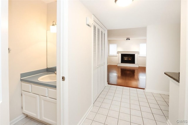 442 Summerhaven Dr N, Manlius, NY 13057 - hallway featuring a sink, light tile patterned flooring, and baseboards