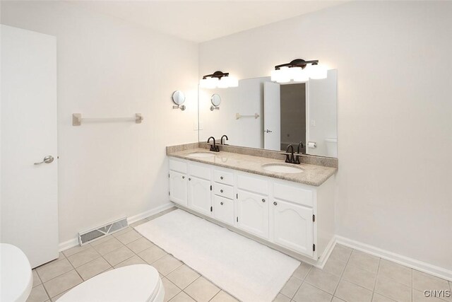 442 Summerhaven Dr N, Manlius, NY 13057 - bathroom with toilet, tile patterned floors, double vanity, and baseboards