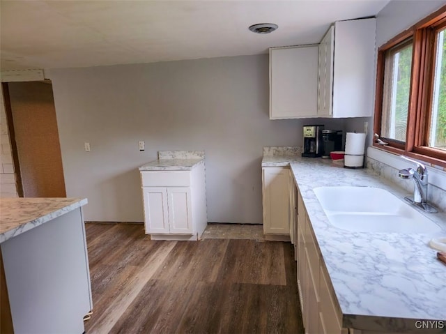 2484 State Route 31, Sullivan, NY 13032 - kitchen with a sink, wood finished floors, light countertops, and white cabinets