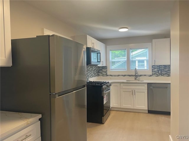 530 Lenox Ave, Oneida, NY 13421 - kitchen with stainless steel appliances, backsplash, white cabinetry, and light countertops