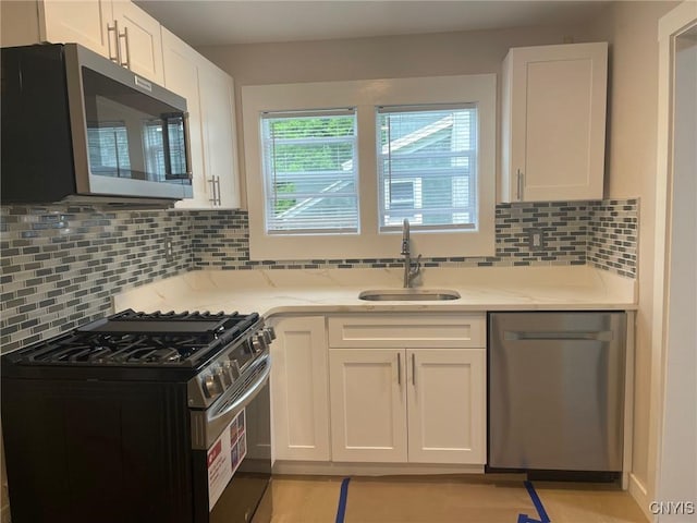 530 Lenox Ave, Oneida, NY 13421 - kitchen featuring appliances with stainless steel finishes, white cabinetry, backsplash, and light stone counters