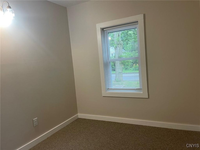 530 Lenox Ave, Oneida, NY 13421 - empty room with baseboards and dark colored carpet