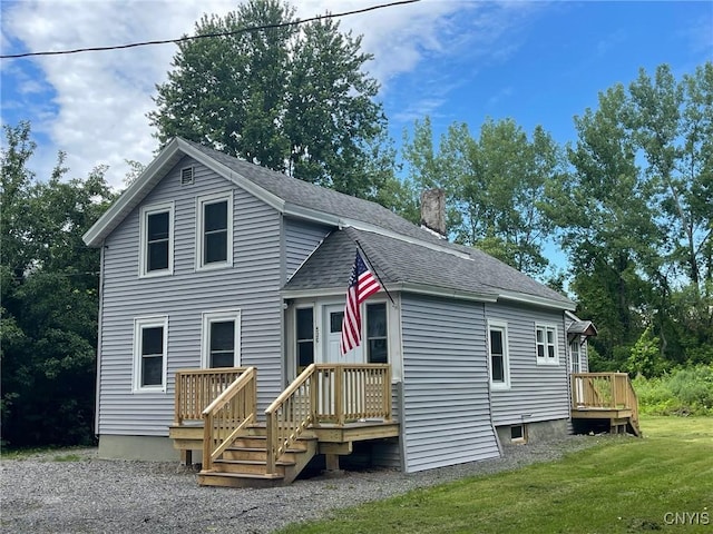 530 Lenox Ave, Oneida, NY 13421 - view of front facade featuring a chimney, a front lawn, roof with shingles, and a wooden deck