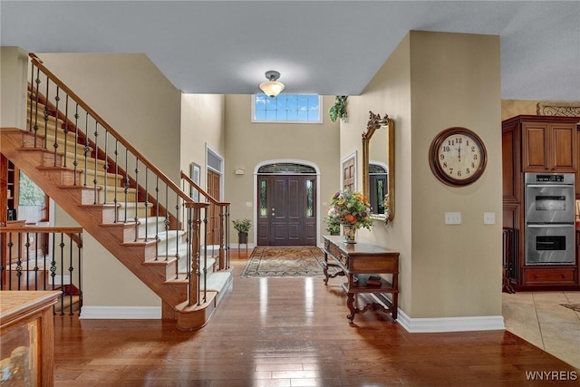 81 Hidden Oaks Ct, Grand Island, NY 14072 - foyer entrance with baseboards, light wood finished floors, and stairway