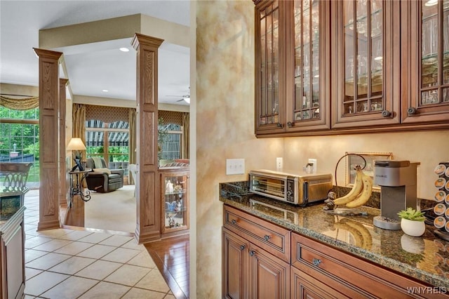 81 Hidden Oaks Ct, Grand Island, NY 14072 - bar area with decorative columns, a ceiling fan, and light tile patterned floors