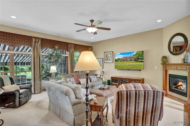 81 Hidden Oaks Ct, Grand Island, NY 14072 - living room featuring ceiling fan, recessed lighting, a glass covered fireplace, and light colored carpet