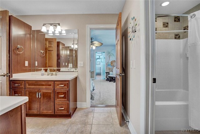 81 Hidden Oaks Ct, Grand Island, NY 14072 - bathroom featuring vanity, tile patterned flooring, baseboards, and shower / tub combo with curtain