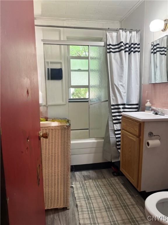 214-16 Reed Ave, Syracuse, NY 13207 - full bath featuring ornamental molding, shower / bath combo with shower curtain, wood finished floors, and vanity