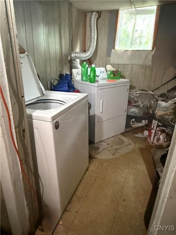 214-16 Reed Ave, Syracuse, NY 13207 - washroom with washing machine and dryer, wooden walls, and light flooring