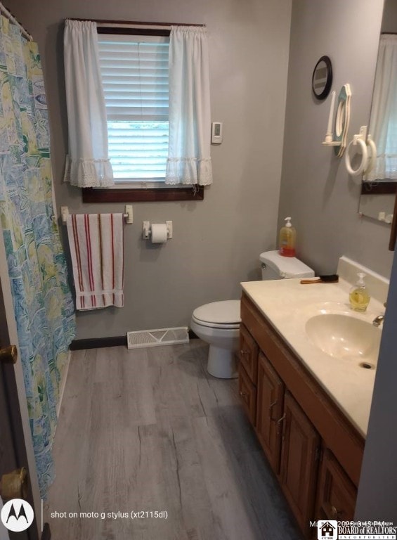 613 N Main St, Pine Grove Township, PA 16345 - full bathroom with vanity, wood finished floors, and curtained shower