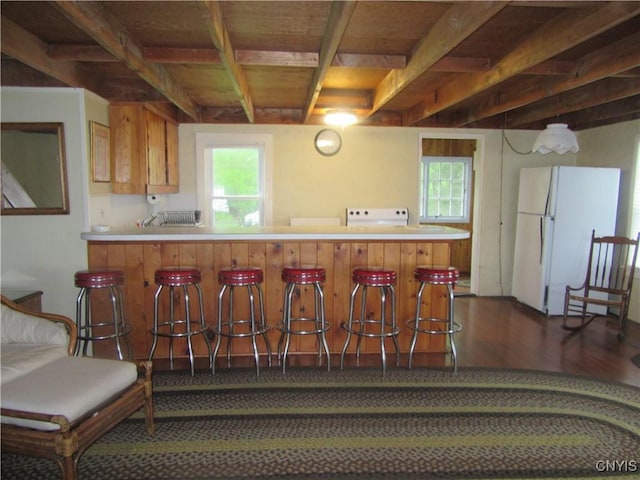 250 Pine Grove Rd Unit 3, Richland, NY 13142 - kitchen with freestanding refrigerator, dark wood-type flooring, plenty of natural light, a peninsula, and beamed ceiling