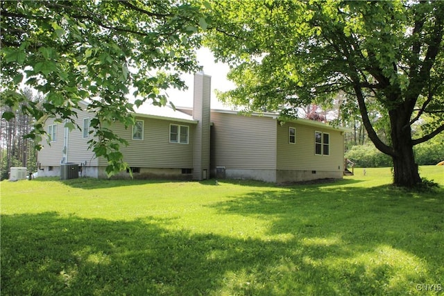 236 Harry Bryant Rd, Amboy, NY 13493 - rear view of property featuring a chimney, a lawn, and central AC