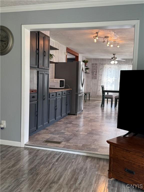 236 Harry Bryant Rd, Amboy, NY 13493 - kitchen with white microwave, dark wood-style floors, open shelves, ceiling fan, and baseboards