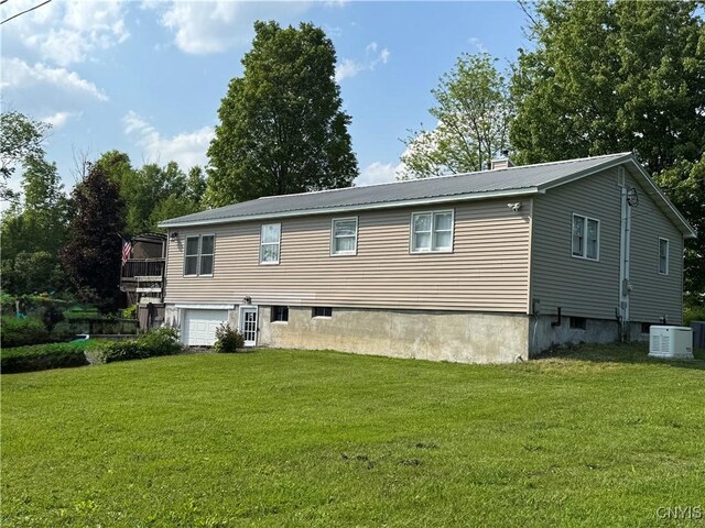 236 Harry Bryant Rd, Amboy, NY 13493 - back of property featuring metal roof, a yard, an attached garage, and cooling unit