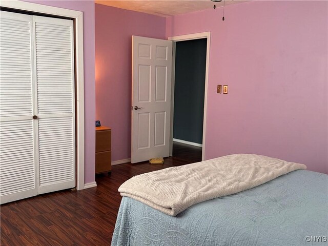 236 Harry Bryant Rd, Amboy, NY 13493 - bedroom with dark wood-style flooring, a closet, and baseboards