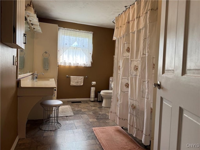 236 Harry Bryant Rd, Amboy, NY 13493 - bathroom featuring toilet, stone finish floors, baseboards, and vanity