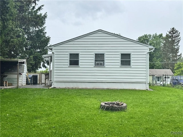 104 Lansdale Rd, Dewitt, NY 13057 - view of side of home featuring an outdoor fire pit and a yard