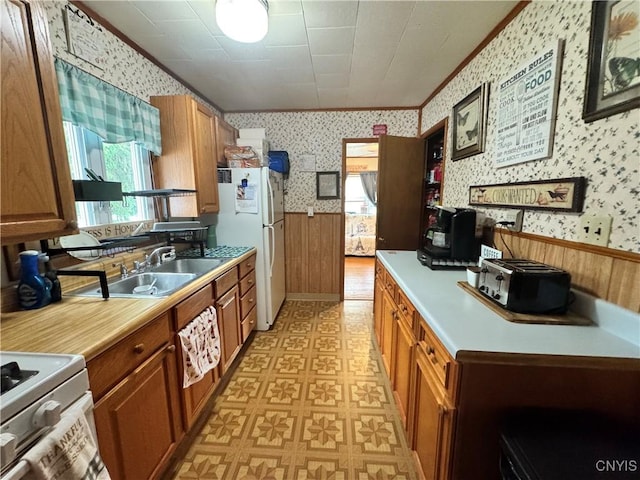104 Lansdale Rd, Dewitt, NY 13057 - kitchen with wallpapered walls, white appliances, a sink, ornamental molding, and a wainscoted wall