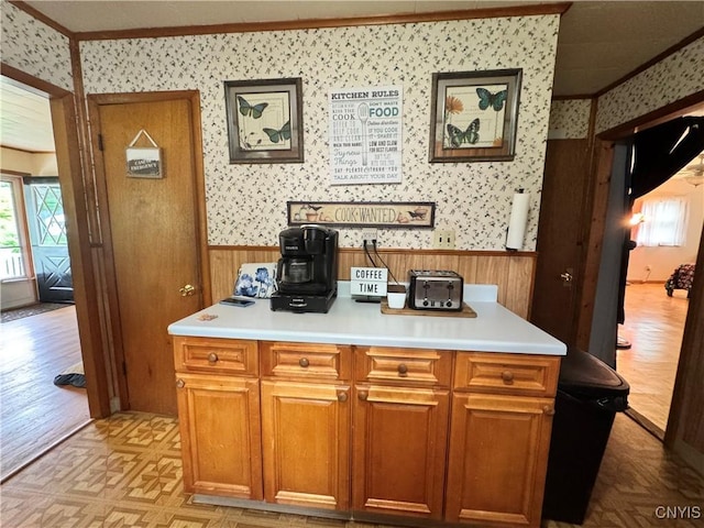 104 Lansdale Rd, Dewitt, NY 13057 - kitchen with wallpapered walls, wainscoting, light countertops, wood walls, and brown cabinets