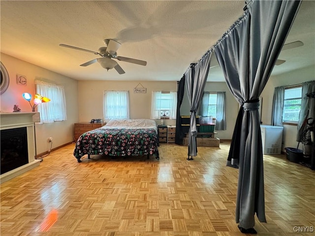 104 Lansdale Rd, Dewitt, NY 13057 - bedroom featuring a textured ceiling, a fireplace, baseboards, and ceiling fan