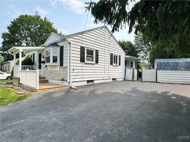 104 Lansdale Rd, Dewitt, NY 13057 - view of front facade with asphalt driveway and a storage shed