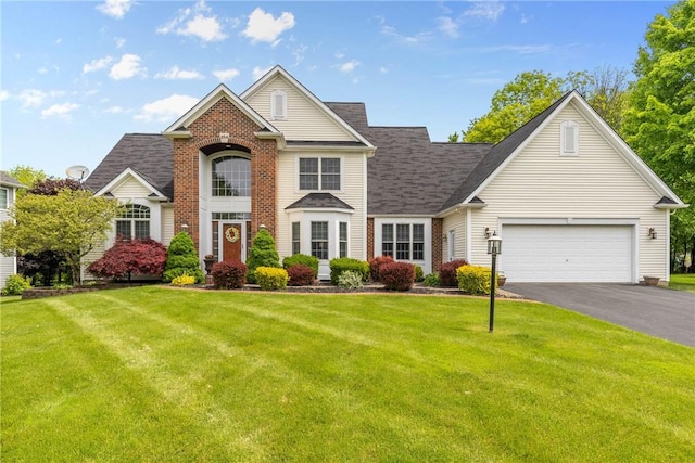 854 Park Haven Dr, Webster, NY 14580 - traditional-style home with asphalt driveway, a front lawn, an attached garage, brick siding, and a shingled roof