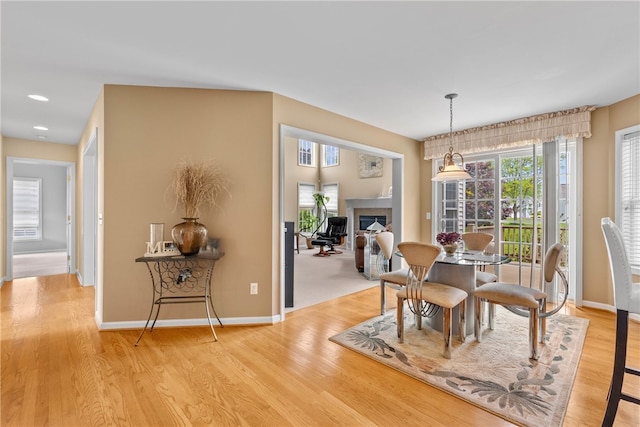 854 Park Haven Dr, Webster, NY 14580 - dining space featuring light wood-style flooring, a fireplace, baseboards, and recessed lighting
