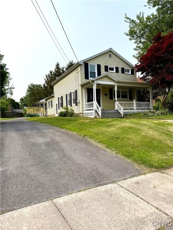 306 Seymour St, Auburn, NY 13021 - view of front of house with a porch and a front yard