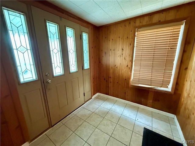 306 Seymour St, Auburn, NY 13021 - entryway featuring wood walls, light tile patterned floors, and baseboards