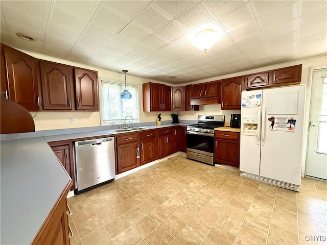 306 Seymour St, Auburn, NY 13021 - kitchen featuring stainless steel appliances, a sink, under cabinet range hood, pendant lighting, and light countertops
