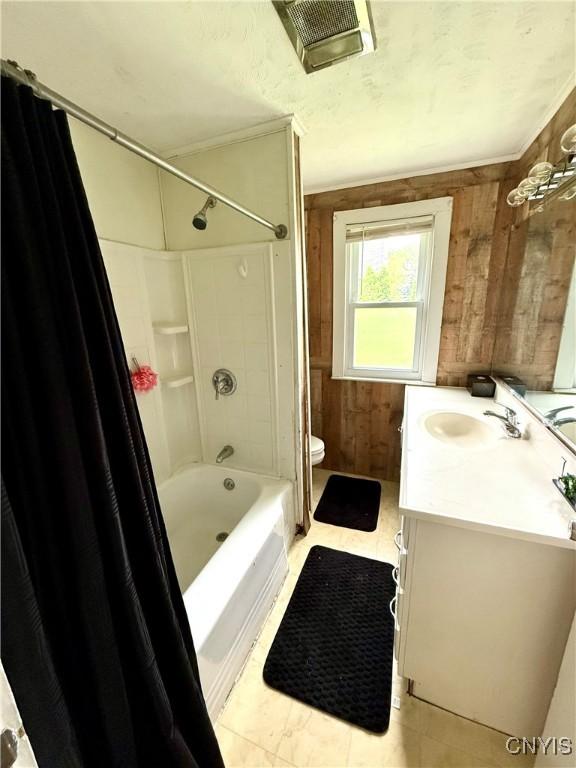 306 Seymour St, Auburn, NY 13021 - full bath with vanity, wooden walls, toilet, and shower / bathtub combination with curtain