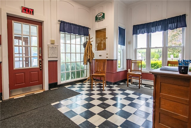 94 Main St, Stamford, NY 12167 - entryway featuring dark flooring, plenty of natural light, a baseboard radiator, and a decorative wall