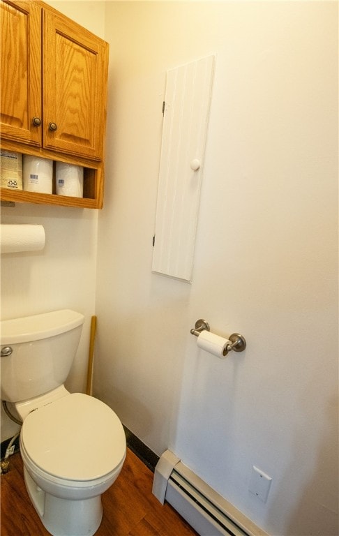 94 Main St, Stamford, NY 12167 - bathroom with wood finished floors, toilet, a baseboard heating unit, and baseboards