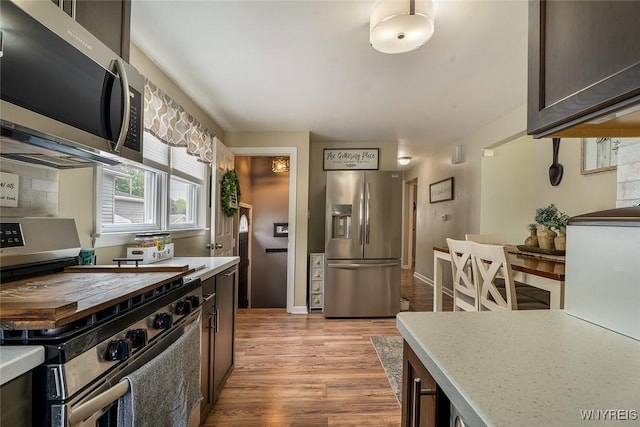157 73rd St, Niagara Falls, NY 14304 - kitchen with stainless steel appliances, light wood-style flooring, light countertops, and dark brown cabinets