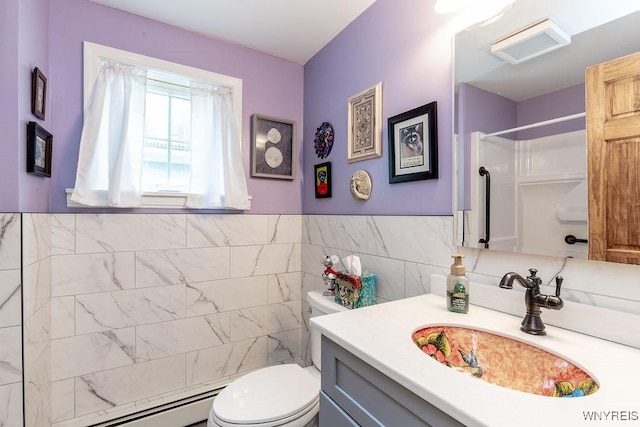 57 Savage Pl, Aurora, NY 14052 - bathroom featuring toilet, vanity, a shower, baseboard heating, and tile walls
