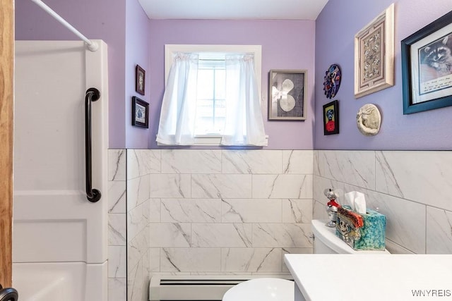 57 Savage Pl, Aurora, NY 14052 - full bath featuring baseboard heating, toilet, a shower, tile walls, and vanity
