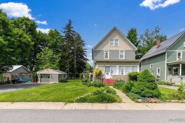 57 Savage Pl, Aurora, NY 14052 - view of front of house featuring a detached garage, an outbuilding, and a front lawn