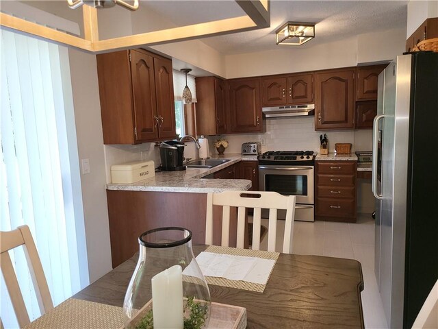 76 Belaire Dr, Big Flats, NY 14845 - kitchen with appliances with stainless steel finishes, a sink, under cabinet range hood, and light countertops