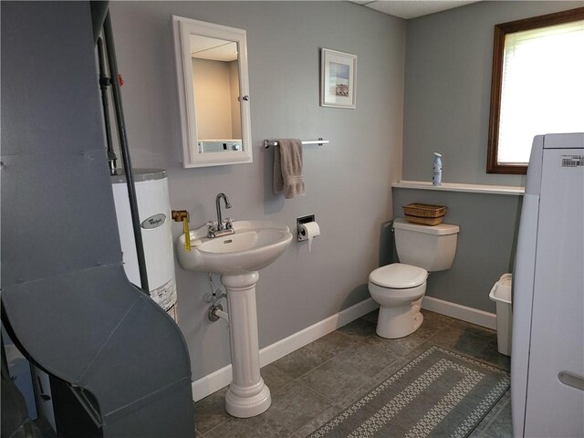 76 Belaire Dr, Big Flats, NY 14845 - bathroom featuring gas water heater, toilet, baseboards, and tile patterned flooring