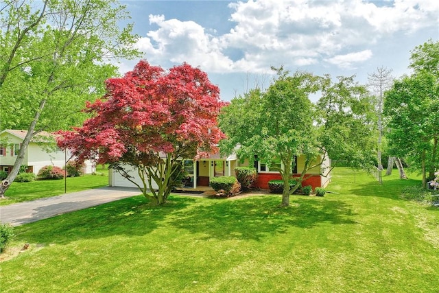 54 Hillary Dr, Chili, NY 14624 - obstructed view of property featuring driveway, a front lawn, and a garage