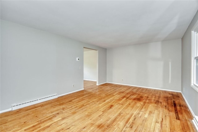 54 Hillary Dr, Chili, NY 14624 - spare room featuring baseboard heating, light wood finished floors, and baseboards