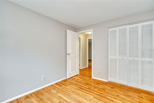 54 Hillary Dr, Chili, NY 14624 - unfurnished bedroom with light wood-type flooring, baseboards, and a closet