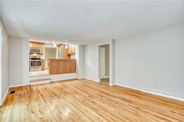 54 Hillary Dr, Chili, NY 14624 - unfurnished living room with baseboard heating, light wood-type flooring, and baseboards